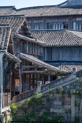 Obraz premium Discover China Wuzhen's ancient architecture, where old stone paths and bridges reflect on peaceful waters. Experience the charm of historic buildings along serene rivers..