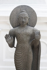 Ancient Buddha statue made of stone. Gangaramaya Temple