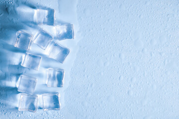 Close-up of Ice Cubes on a Light Blue Surface with Water Droplets - Refreshing and Cool Concept for...