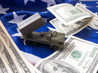 Image of a toy military vehicle guarding the American flag 