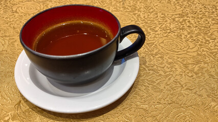 Brewed tea on a serving table with brewing