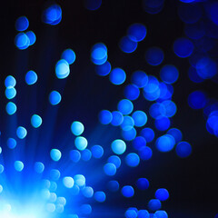 Festive blue and black background with boke and blue light in the corner