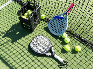 Paddle racket with a ball ready to play the fastest growing sport in recent years worldwide. Padel...