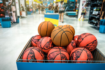Basketball balls in a basket in the sport store, market