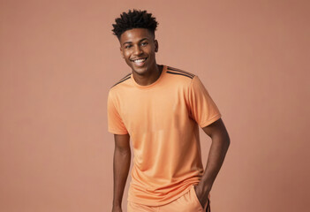 A soccer player posing confidently in an orange jersey, his playful attitude shines through.