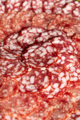 Thin slices of smoked sausage close-up.