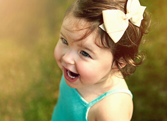 Excited, toddler or girl child outdoor in nature for play, fun and adventure on summer weekend. Young kid, happy and outside in garden for explore environment, growth and development on field