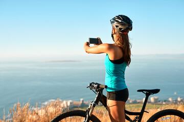 Girl, cyclist and outdoor with photography of view for travel blog, memory and social media post or content creation. Woman, smartphone and mountain for trail riding, cycling and adventure on holiday