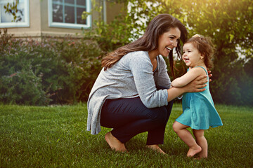 Mother, daughter and bonding with playing in garden for fun activity, support or smile outdoor in...