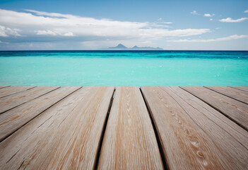 Fototapeta premium Summer vibes: A tranquil scene of wooden planks against the backdrop of the blue ocean and sky
