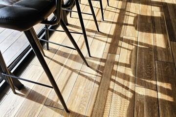 Shadow of chairs on the wood floor.