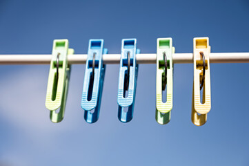 clothespins on a clothesline against the blue sky in spring