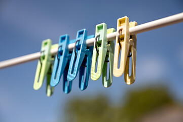 clothespins on a clothesline against the blue sky in spring