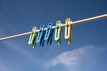 clothespins on a clothesline against the blue sky in spring