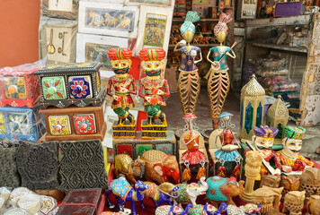 Fototapeta premium A Collection of Colorful Dolls and toys made from wood and metal representing Rajasthani culture and sold as souvenirs at Jaipur in India.
