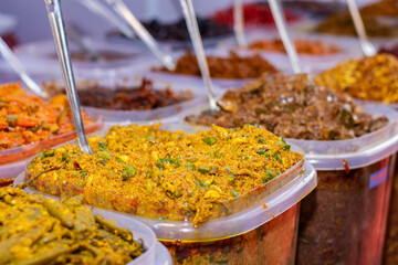 A seller selling delicious Indian Aachar or pickles items at Industrial trade fair in Kolkata, West Bengal, India.