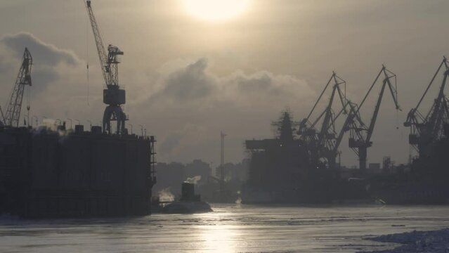 Nuclear icebreakers, portal cranes and submarines in winter mooring. Russia