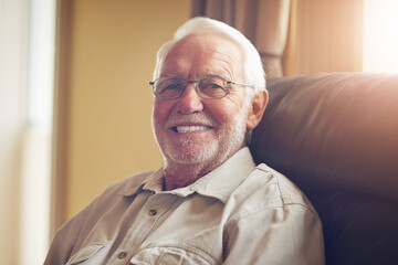 Portrait, elderly man and smile on sofa in living room for relax, retirement or good mood....