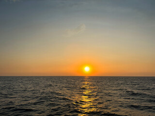 Sunset beach landscape. Sea view with rocky beach, and grassy park. A view from Varadero Beach. The photo captures a breathtaking view of a serene beach with crystal-clear waters and gentle
