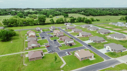 Row of new development houses lush greenery farmland at Wyandotte, small town in Ottawa County,...