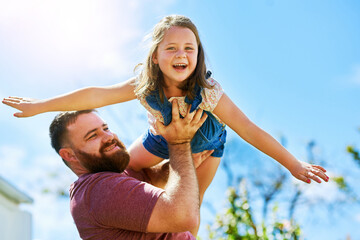 Obraz premium Dad, kid and playing in backyard with flying, smile and fun on outdoor adventure with weekend games. Energy, father and girl in garden together in playful support, trust or happy growth with airplane