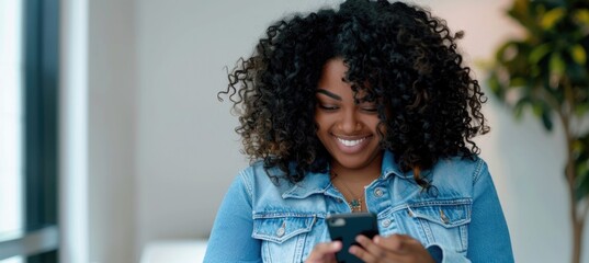 A beautiful smiling African American woman using a mobile phone.
