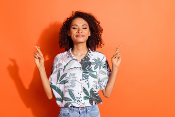 Photo of funky young positive girl with curly hair in summer shirt keeping balance meditation...