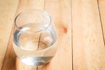 glass of water on wooden table