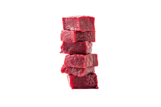 Raw beef meat cubes scattered across a white surface, like dice on a game board, isolated on white background