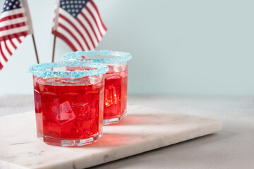 Patriotic red pomegranate margarita cocktail on gray background. Festive beverages for Independence...