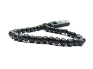 Prayer beads in shape of crescent for Ramadan on grey background