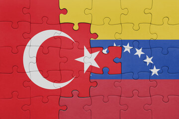 puzzle with the colourful national flag of venezuela and flag of turkey.