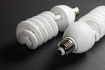 Energy saving fluorescent light bulb on dark background