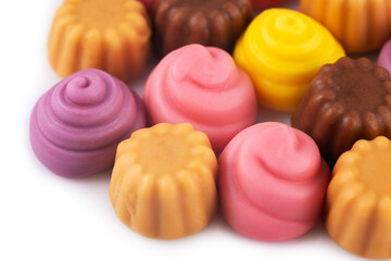 Pile jelly candies in the form of a meringue and cupcake isolated on white
