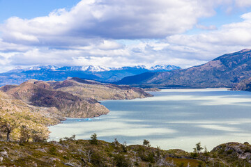 Torres del Paine national park in Patagonia Andes, Chile. South America mountain landscape. Beautiful mountains Los Cuernos, Torres del Paine and Paine Grande tower peaks near lake on a sunny day