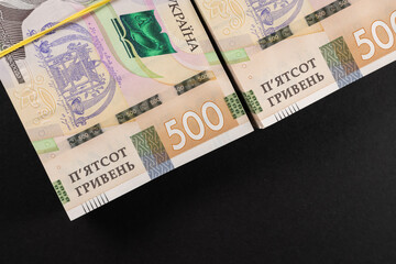 bundles of hryvnia on a black background. Ukrainian money. 500 hryvnia banknotes. A lot of Ukrainian money.