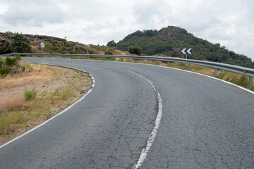 Driving car on asphalt curved highway, road passing national park with rocky mountains. Travel nature by vehicle with picturesque mountain landscape.