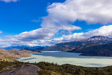 Torres del Paine national park in Patagonia Andes, Chile. South America mountain landscape. Beautiful mountains Los Cuernos, Torres del Paine and Paine Grande tower peaks near lake on a sunny day