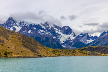 Fototapeta premium Torres del Paine national park in Patagonia Andes, Chile. South America mountain landscape. Beautiful mountains Los Cuernos, Torres del Paine and Paine Grande tower peaks near lake on a sunny day