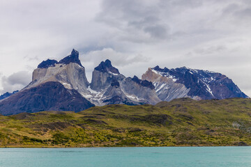 Torres del Paine national park in Patagonia Andes, Chile. South America mountain landscape. Beautiful mountains Los Cuernos, Torres del Paine and Paine Grande tower peaks near lake on a sunny day