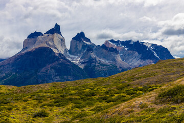 Torres del Paine national park in Patagonia Andes, Chile. South America mountain landscape. Beautiful mountains Los Cuernos, Torres del Paine and Paine Grande tower peaks near lake on a sunny day