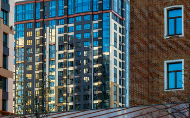 Fototapeta premium Fragments of the walls of old and new buildings in the city.