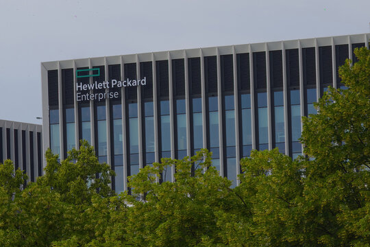 Closeup of Hewlett Packard Enterprise sign on modern building facade in the street.
