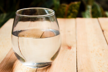 glass of water on wooden table