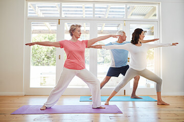 Obraz premium Yoga, fitness and mature couple with instructor for stretching, health and wellness in pose in class. Workout, senior man and woman on mat for body care, balance and exercise together with teacher