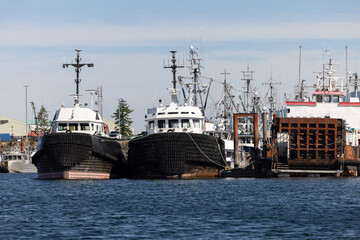 Large fishing and tugboats moored in harbor