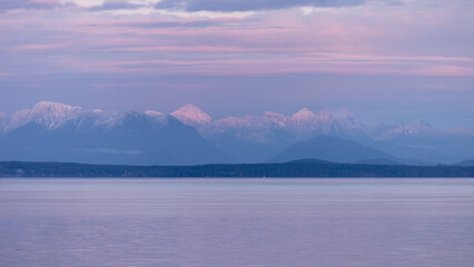 Sunset over British Columbia mountains at sea