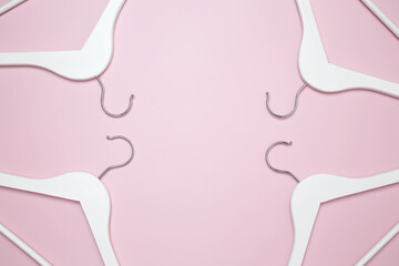 Creative flat lay hangers pink background. Sale discount store promo shopping concept. Top view. Copy space