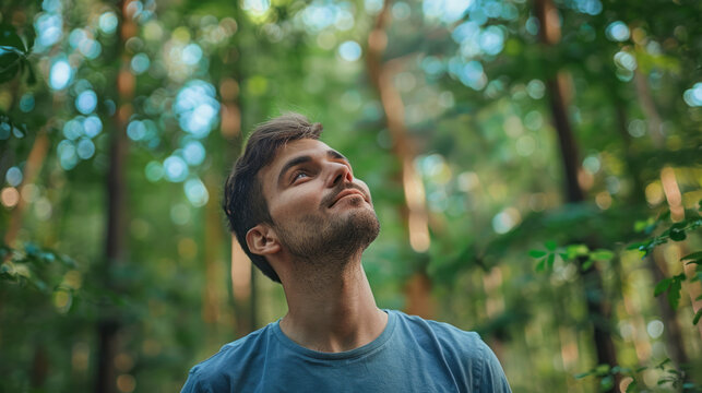 Relaxed adult man breathing fresh air in a forest