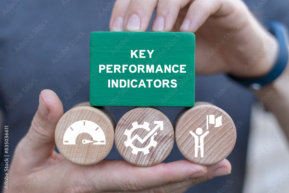 Poster man holding blocks with icons sees inscription: key performance indicators. kpi - key performance in